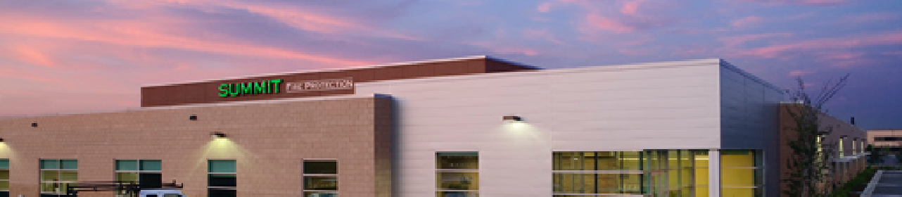 A Summit office building against a sunset background