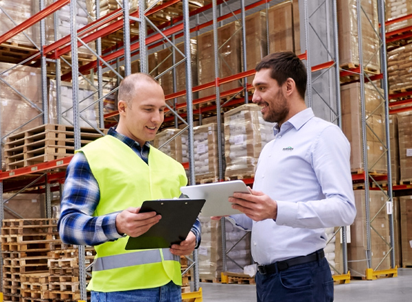photo of two men in warehouse talking through fire codes