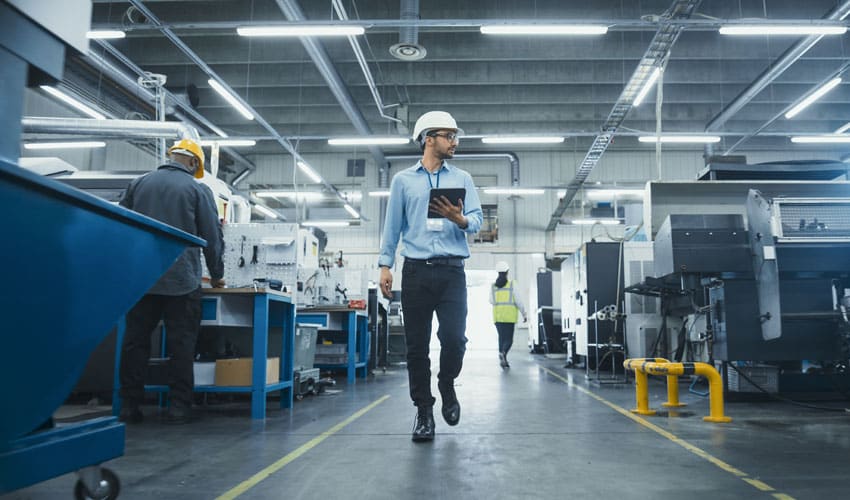 Worker walking in manufacturing facility.