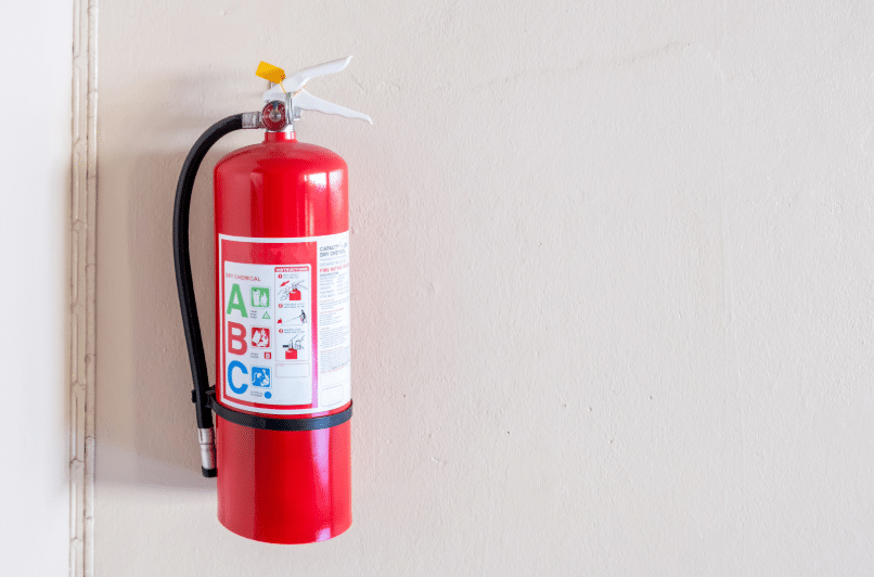 Red fire extinguisher on wall