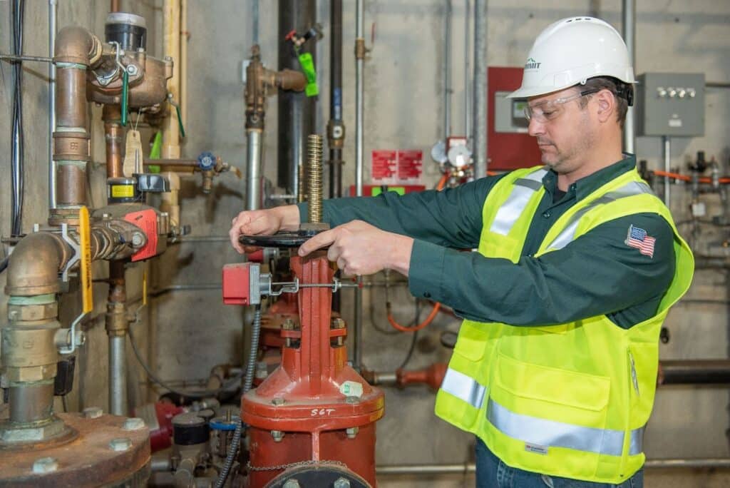 A Summit Fire & Security inspector inspecting a fire protection system