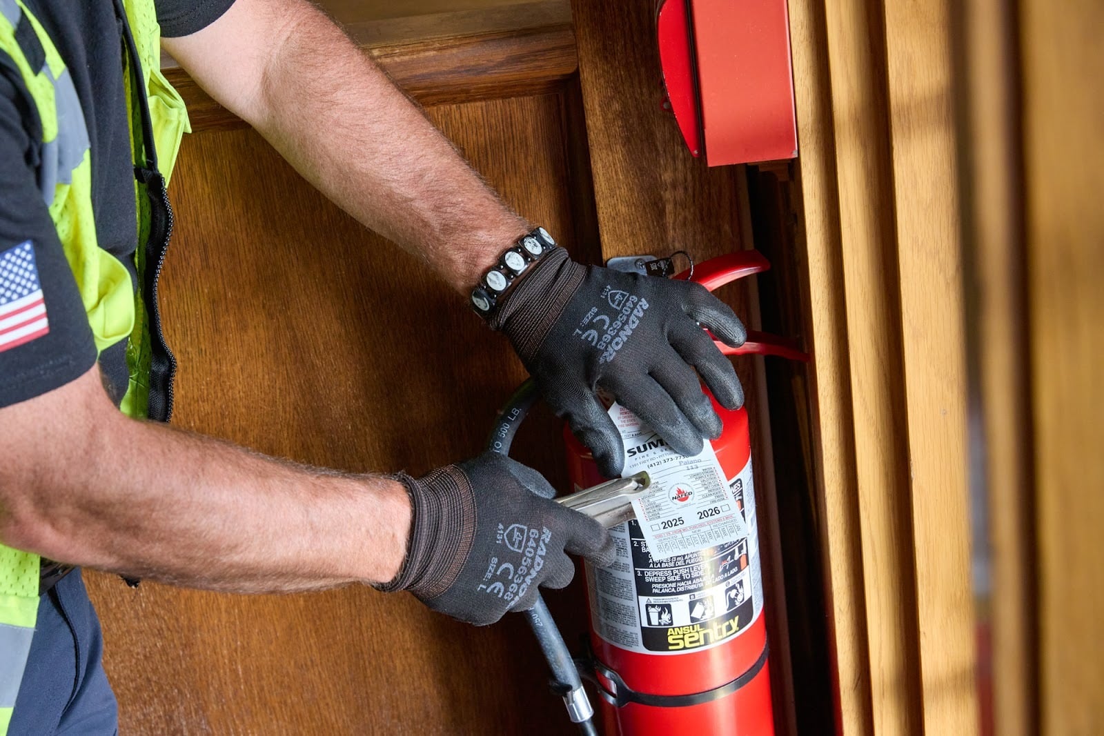 Summit Fire & Security employee completing an inspection of a fire extinguisher