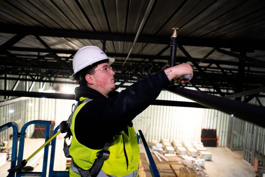 Technician working on an industrial sprinkler